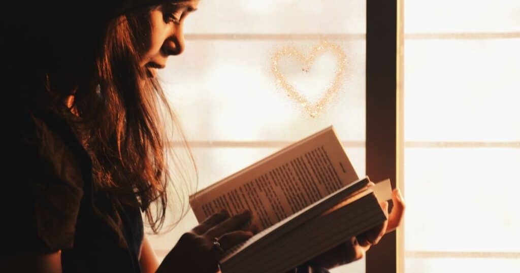 Girl immersed in a book. A love of reading begins with a strong oral language foundation.