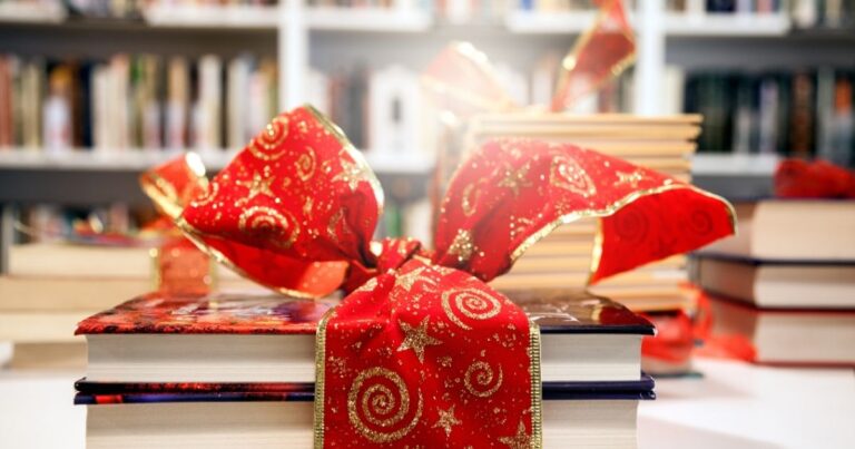 Books for family read alouds with a bow tied around them for a gift.